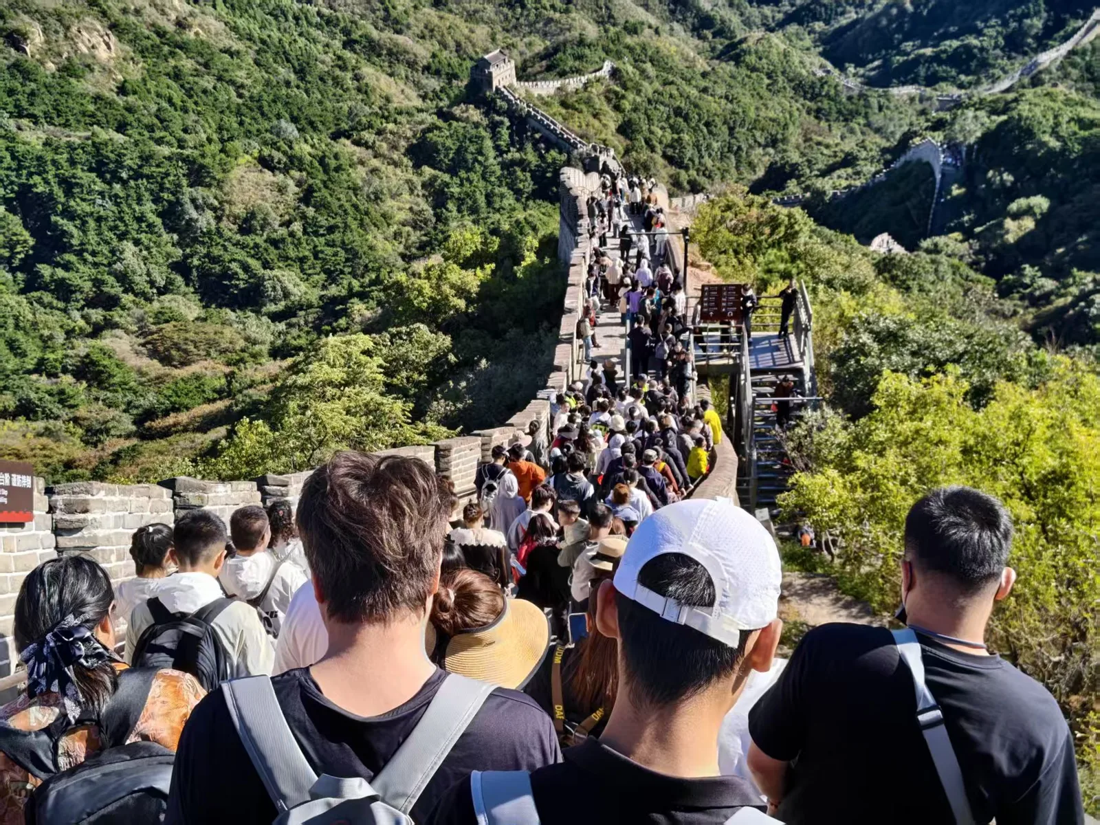 沿山势延伸的长城与游客
